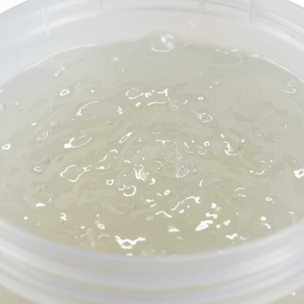 Close-up view of Texapon liquid (SLES) inside the container, showing the texture, transparency and color of the liquid, white background